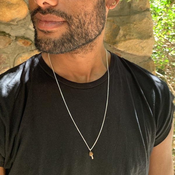 Model wearing gold vermeil and oak lucky forager pendant