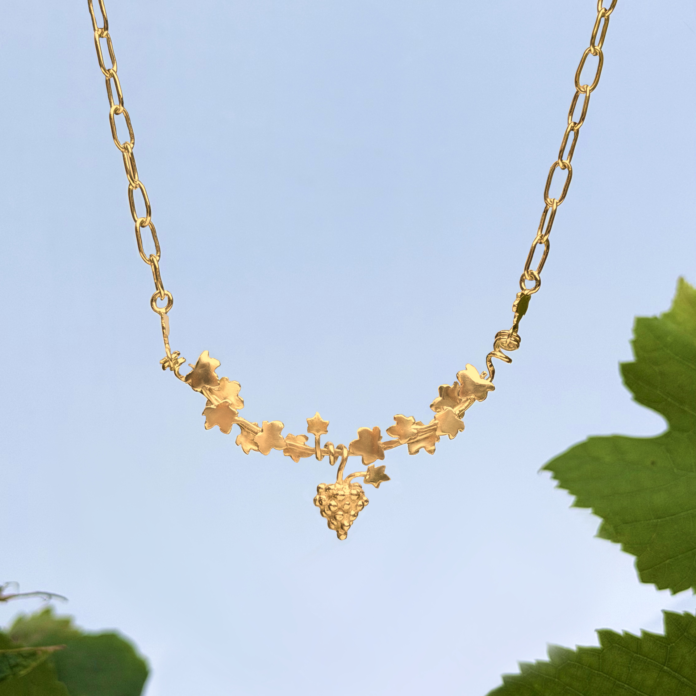 Gold twisting vine leaves and grapes necklace